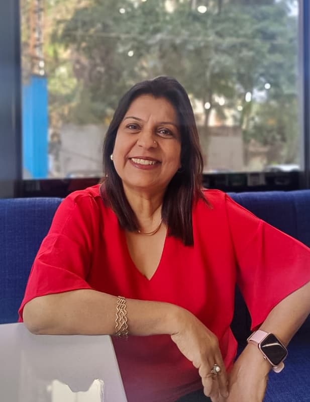 Parineeta collaborating with a team in a bright modern office setting